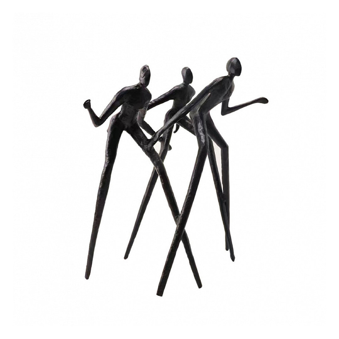Black abstract sculpture of three figures in a dynamic pose on a white background