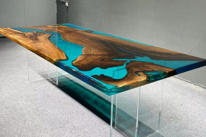 Modern dining table with wooden and blue resin design in a room.