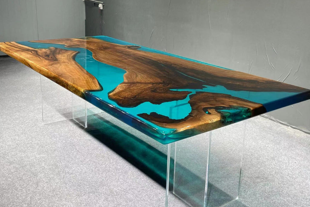 Modern dining table with wooden and blue resin design in a room.