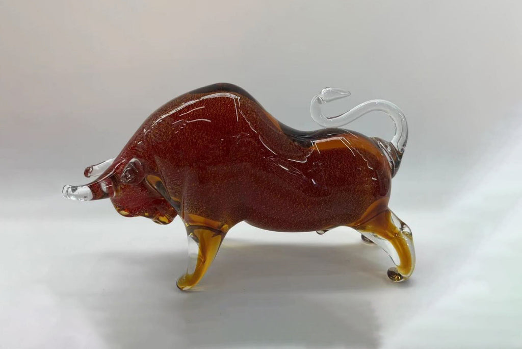 Glass sculpture of a bull on a white background