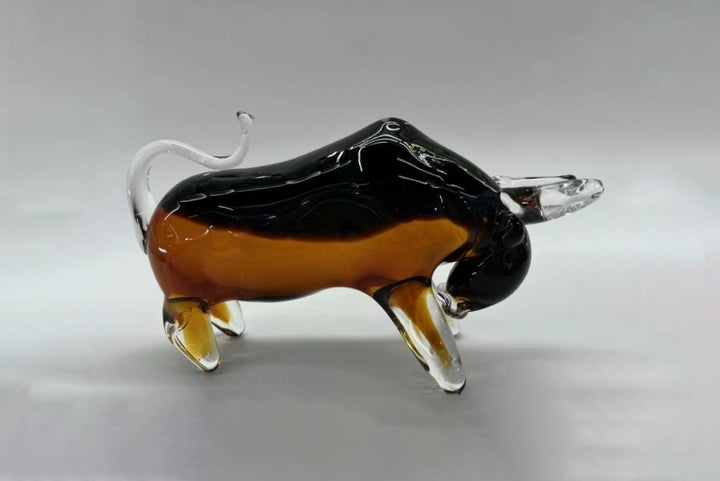 Glass sculpture of a bull on a gray background