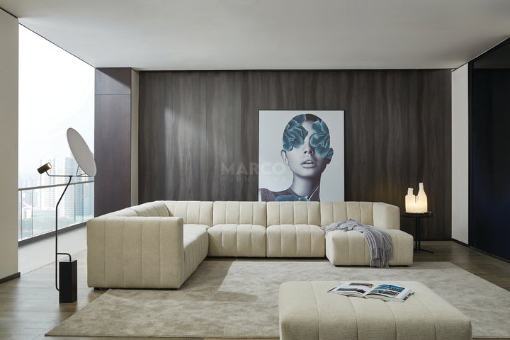 Modern living room with a beige sectional sofa, coffee table, and wall art.