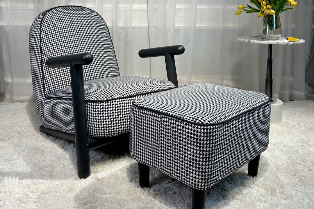 Black and white checkered armchair with ottoman in a room setting.