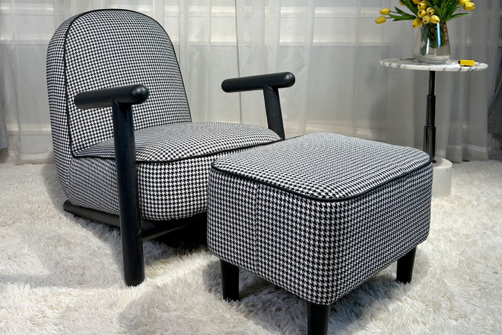 Black and white checkered armchair with ottoman in a room setting.