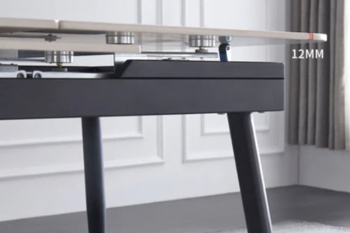 Close-up of a black desk with a 12mm label in a room with a window and curtain.