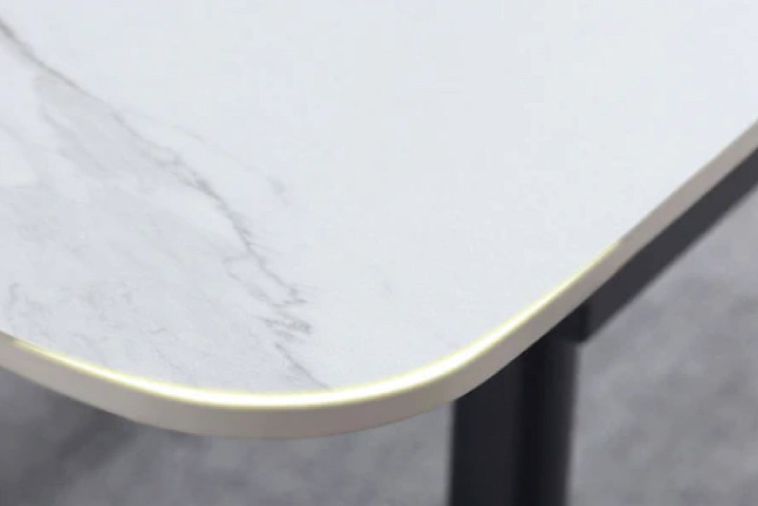 Close-up of a table with a marble-like surface and black leg.