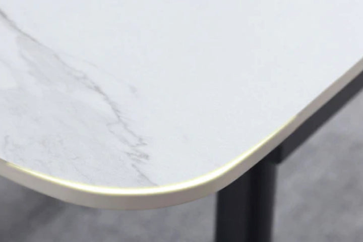 Close-up of a table with a marble-like surface and black leg.