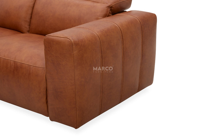 Brown leather sofa corner with 'Marco' brand name on a white background