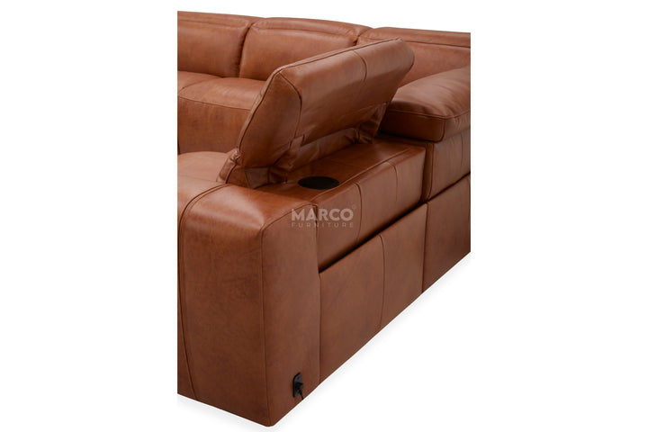 Brown leather sectional sofa with cup holder and power button on a white background