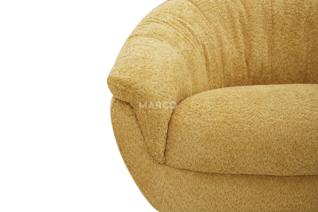 Close-up of a textured beige sofa with 'Marco' branding.