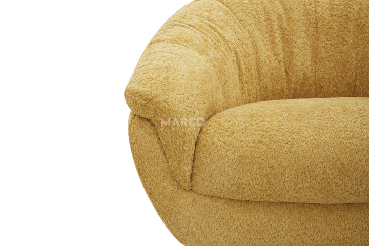 Close-up of a textured beige sofa with 'Marco' branding.
