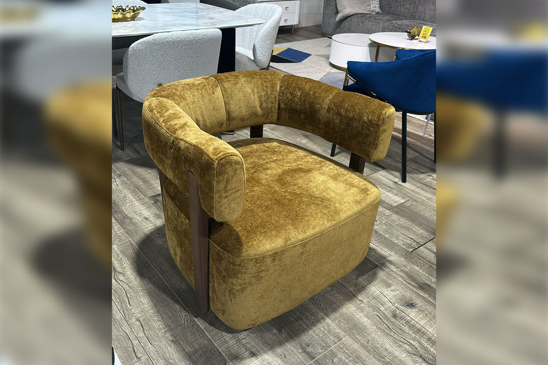 Gold armchair in a room with a blurred background