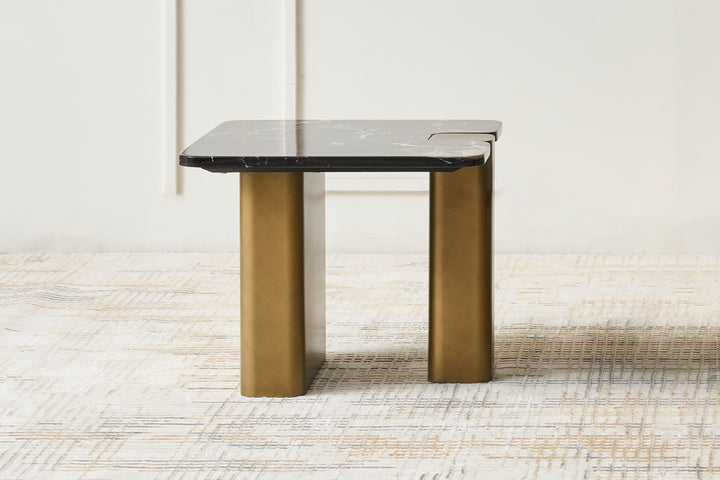 A black rose marble top end table with powder-coated metal legs in gold color, placed on a light rug.