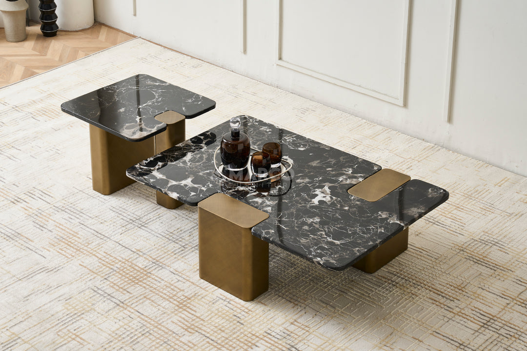 A black rose marble top end table with gold powder-coated metal legs on a patterned floor, part of a coffee table set.