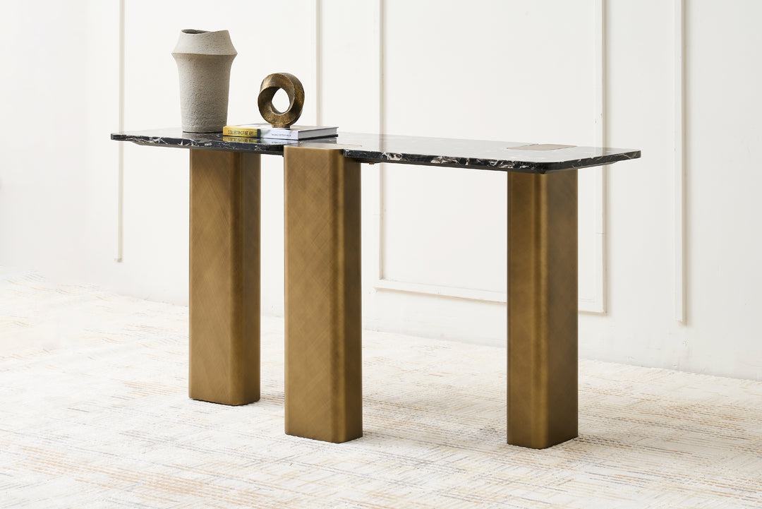 Modern console table with marble top and bronze legs against a white wall.