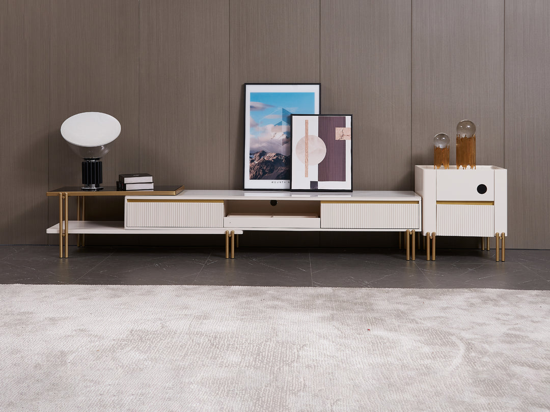 Modern entertainment console with gold legs and artwork against a wooden wall.