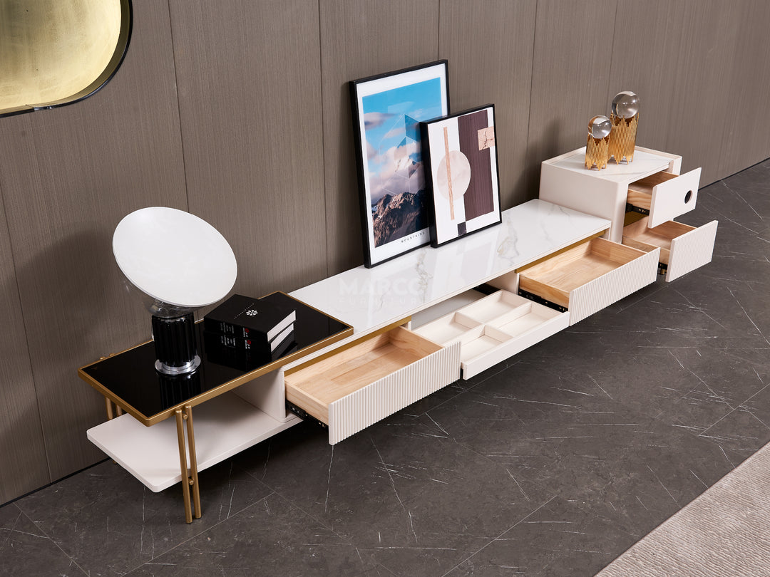 Modern entertainment console with marble surface and gold accents against a neutral background.