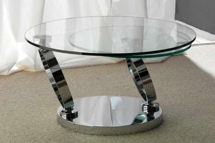 Glass coffee table with chrome base on carpeted floor.