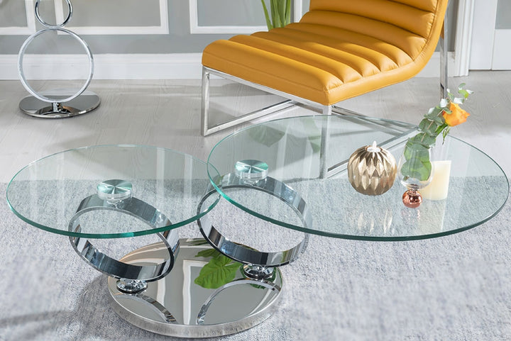 Glass coffee table with metal base in a modern living room.