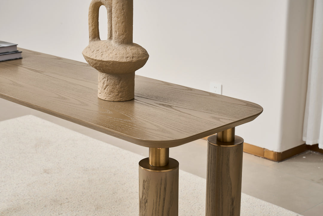 Wooden table with a textured vase on top in a minimalistic setting