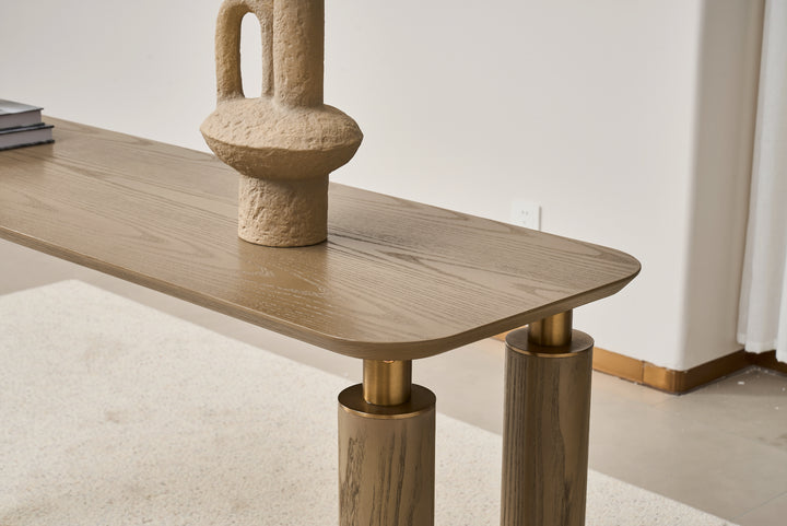 Wooden table with a textured vase on top in a minimalistic setting