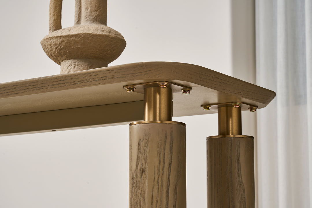 Close-up of a wooden and brass lamp with a neutral background