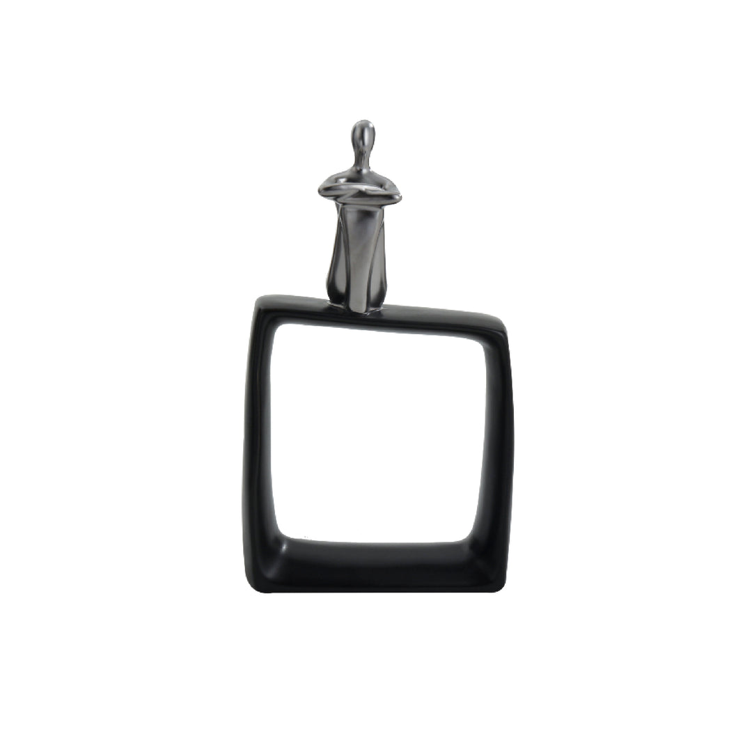 A black ceramic abstract figurine of a thinking man sitting on a cubic block, with a glossy finish and a metal handle for attachment.