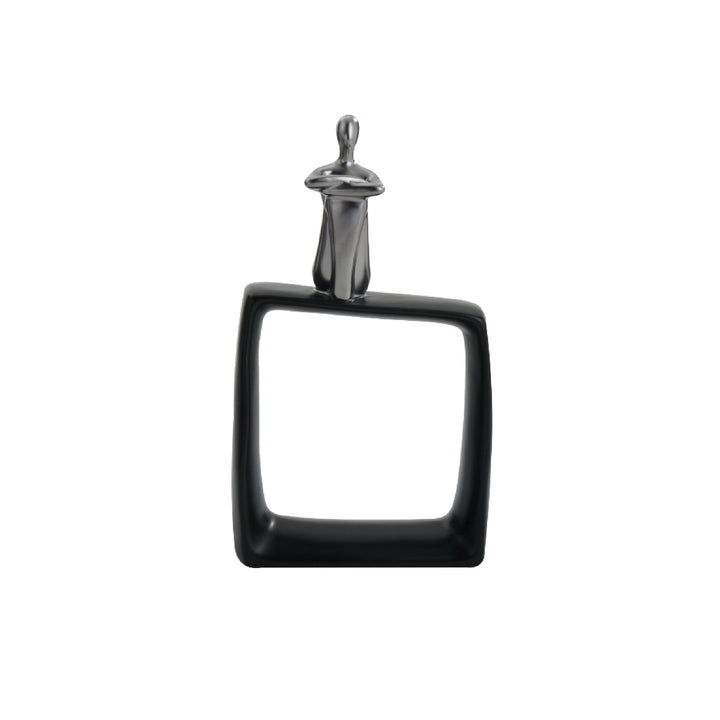 A black ceramic abstract figurine of a thinking man sitting on a cubic block, with a glossy finish and a metal handle for attachment.