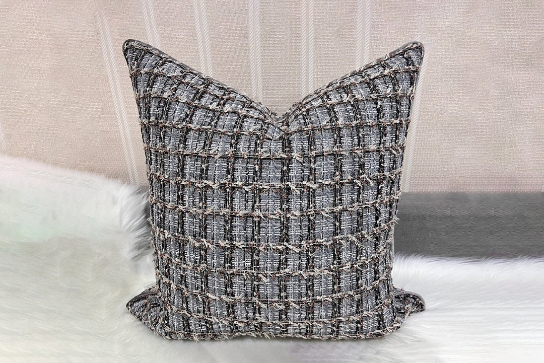 Textured pillow on a sofa with a neutral background