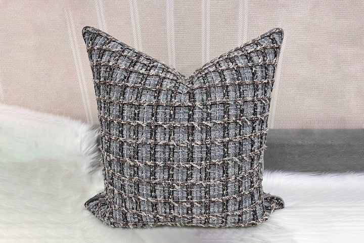 Textured pillow on a sofa with a neutral background