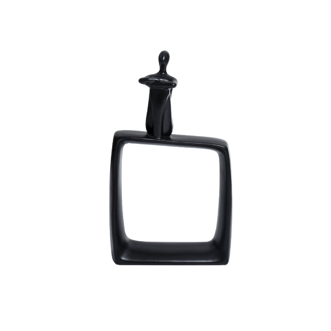 A black ceramic abstract art statue featuring a cubic base with a thinking man figure on top, placed against a white background.