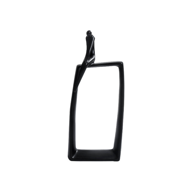 A black ceramic sculpture of a sitting man alone, with a glossy black rectangular base.