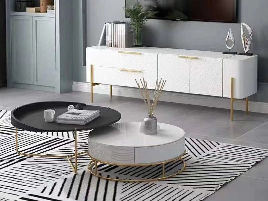 Modern living room with a black and white color scheme featuring a coffee table and sideboard.