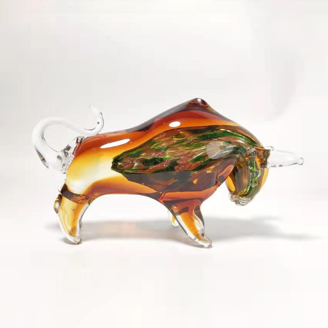 Glass sculpture of a bull with multicolored patterns on a white background