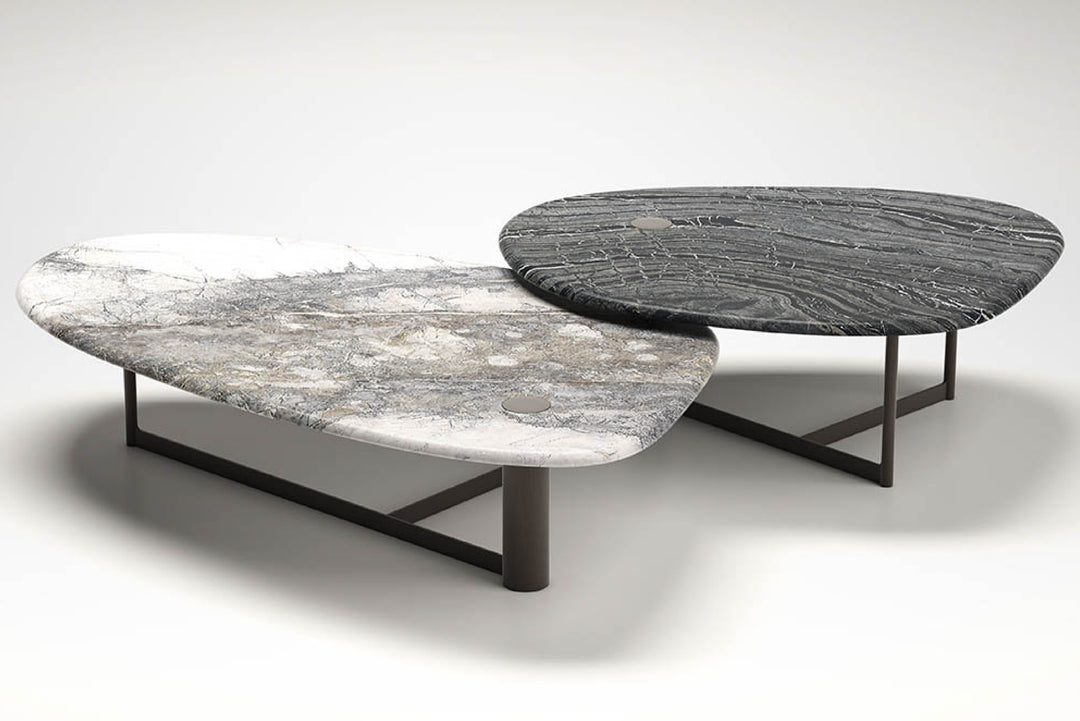 Two round marble coffee tables, one white and one gray, on a white background.