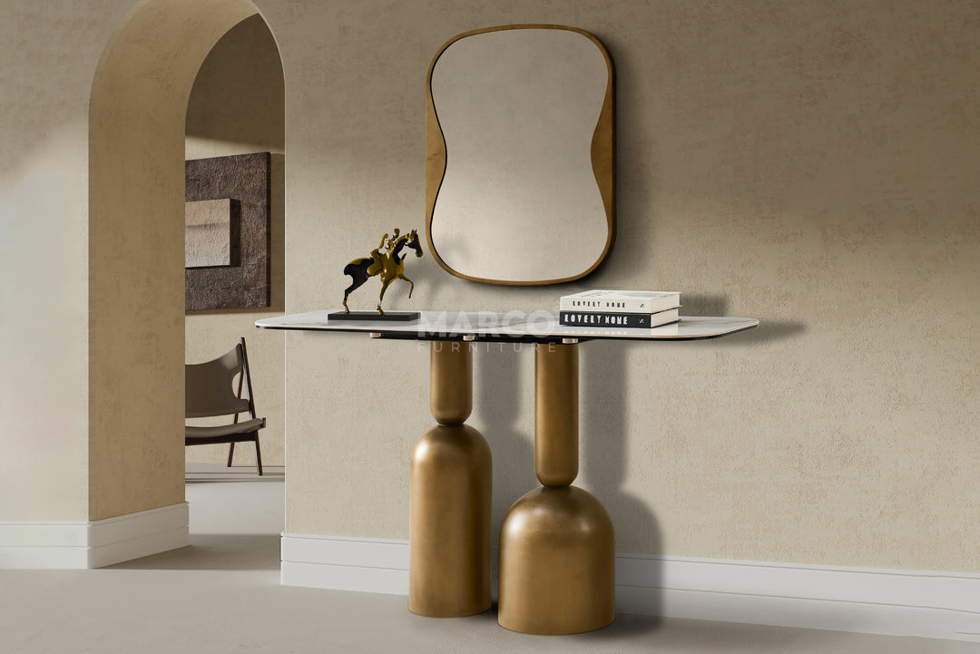 Modern console table with a mirror and decor items against a beige wall.