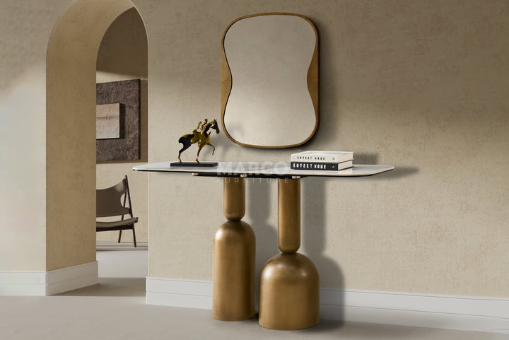 Modern console table with a mirror and decor items against a beige wall.