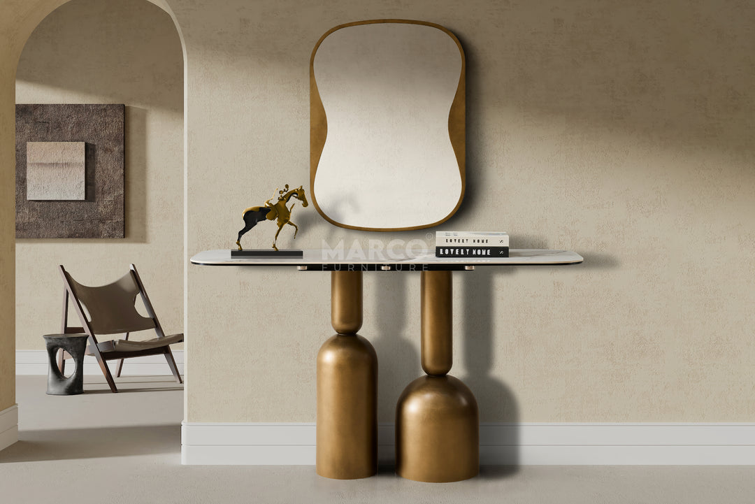 Modern console table with a mirror and decorative items against a beige wall.