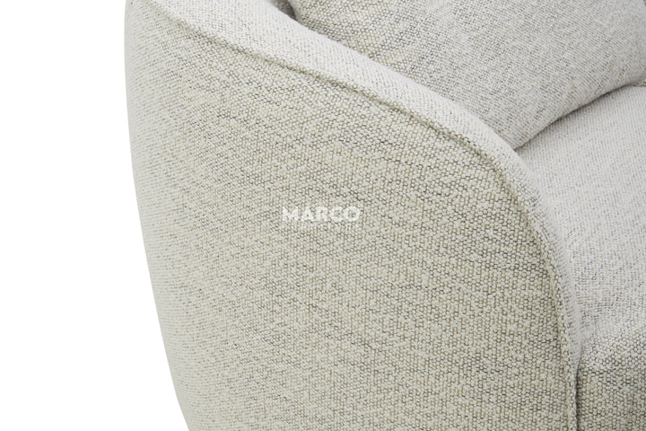 Close-up of a textured gray sofa with 'Margo' branding.