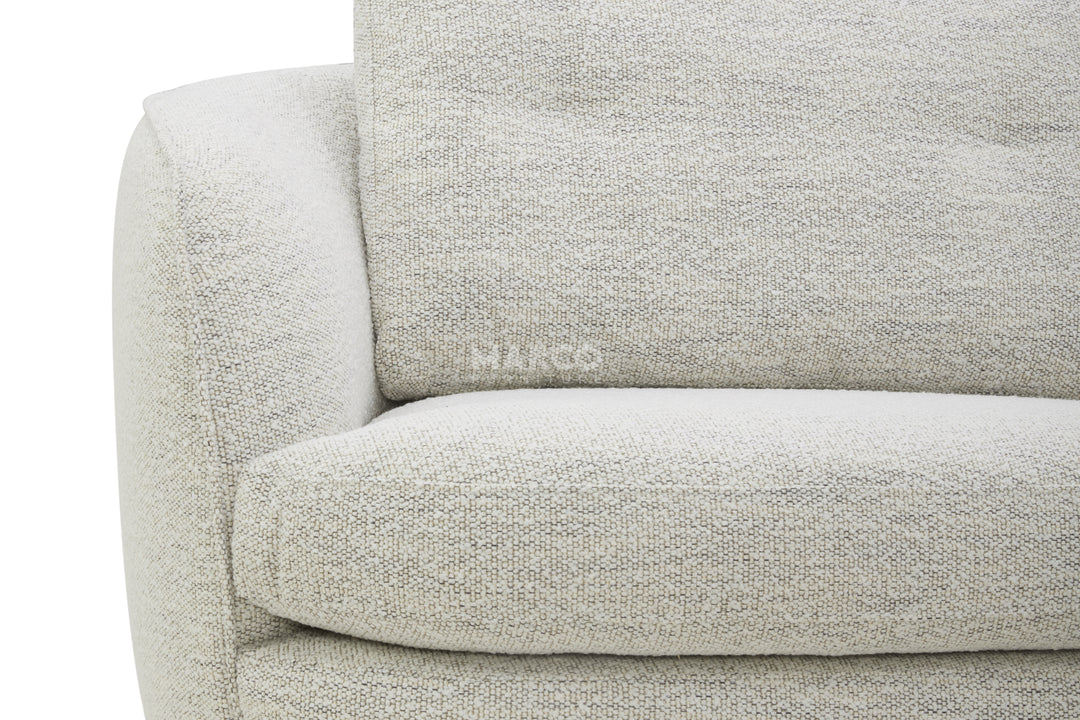 Close-up of a light gray sofa with 'MARCO' branding on a white background