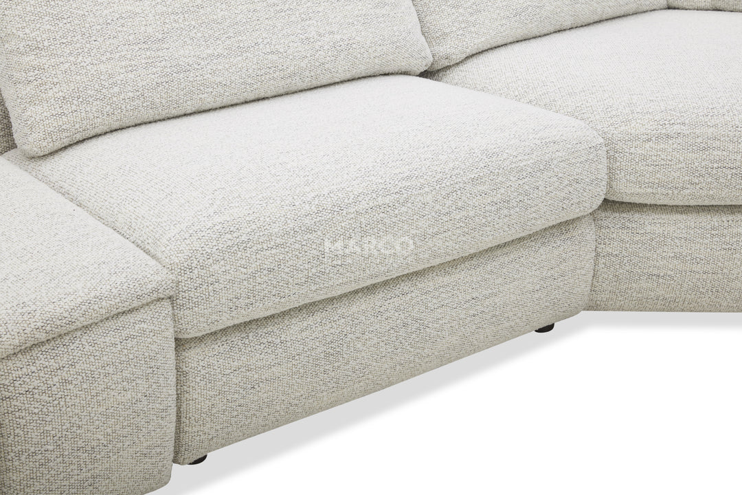 Close-up of a light gray sectional sofa with 'Ekko' branding.