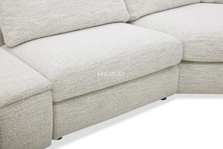 Close-up of a light gray sectional sofa with 'Ekko' branding.