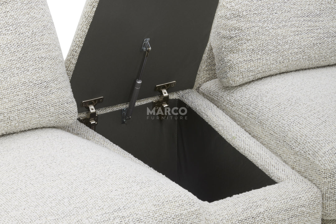 Gray upholstered sofa with a hidden compartment, brand 'Marco' visible.