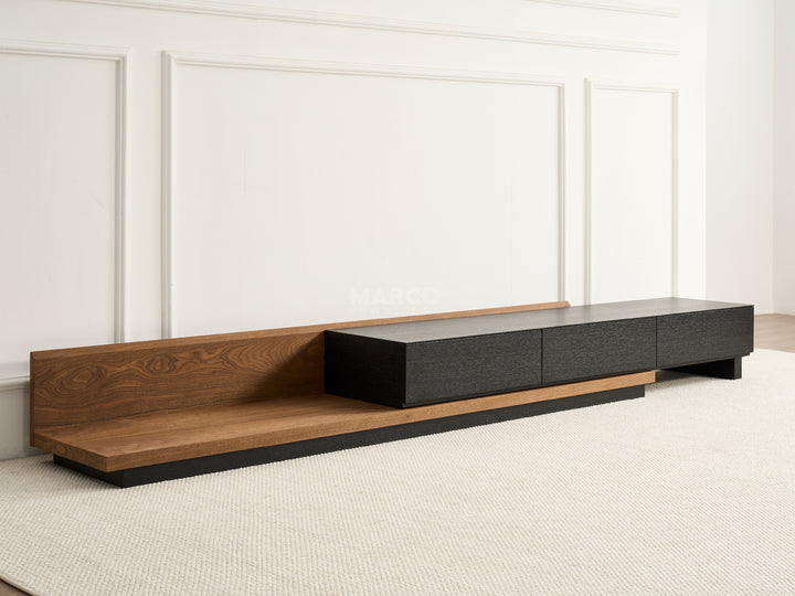 Modern TV stand with wooden and black design against a white wall.