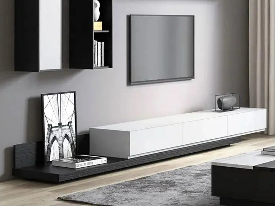 Modern living room with a white entertainment console and black and white decor.