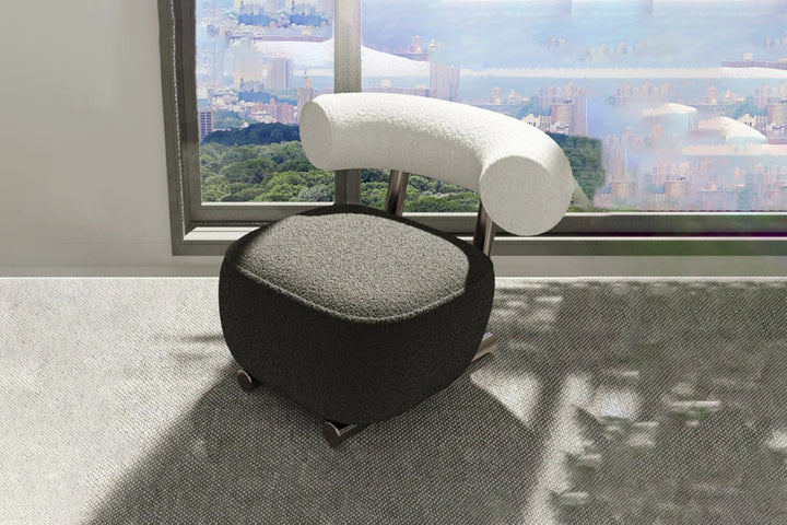 Modern chair with a gray seat and white backrest in a room with large windows showing a cityscape.