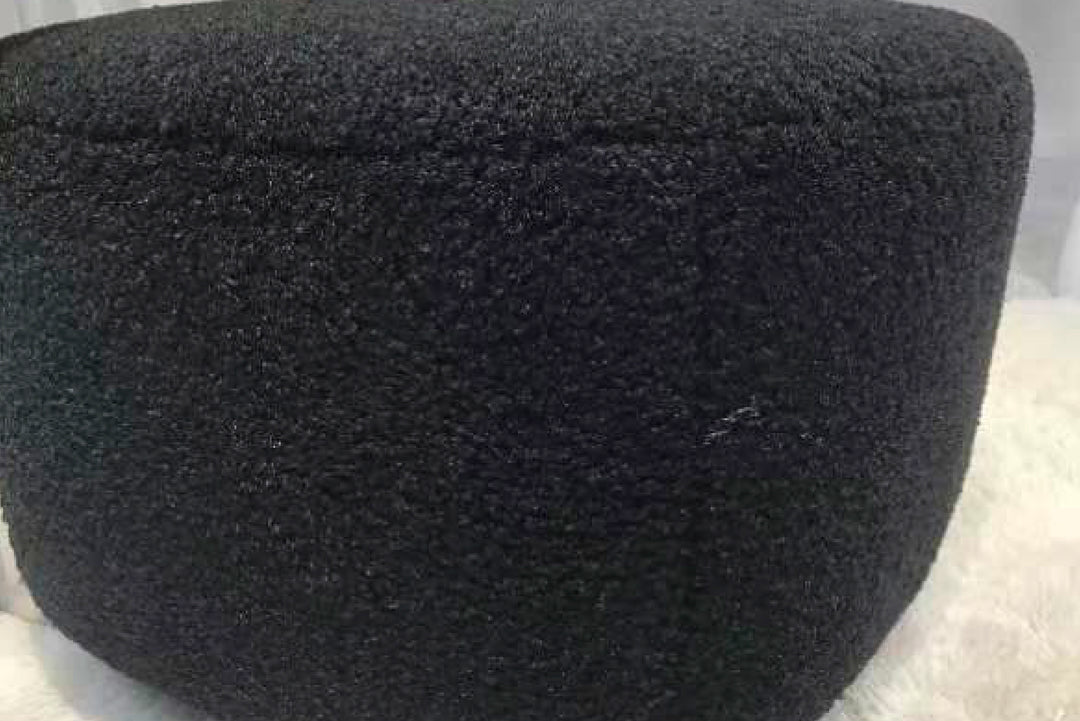 Black woven basket on a light gray background