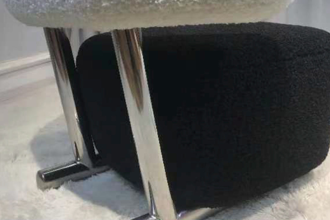 Black office chair with a metallic frame on a light-colored floor.