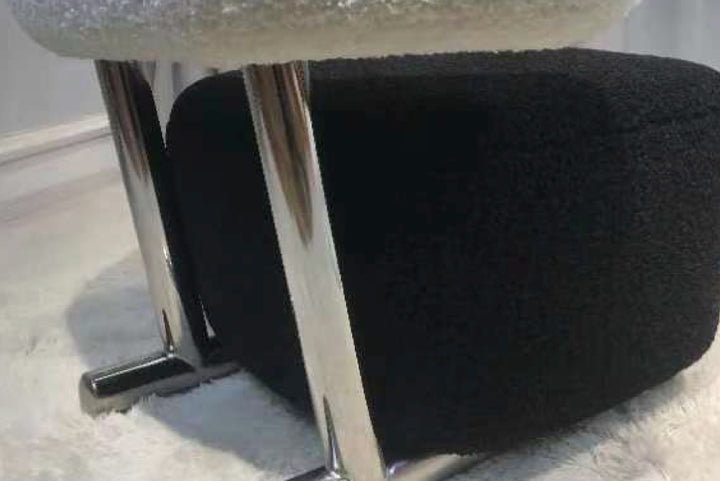 Black office chair with a metallic frame on a light-colored floor.