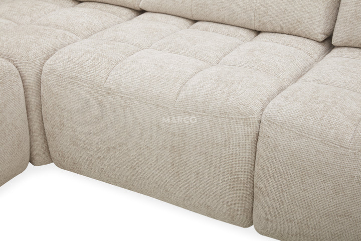 Beige fabric sofa with a visible brand logo on a white background